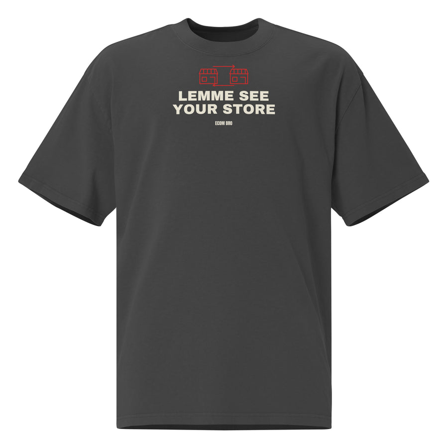 Supplier mockup, front of Faded Black cotton tee with red DTG storefront graphics, cream LEMME SEE YOUR STORE text and ECOM BRO signature.