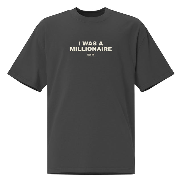 Supplier mockup of the Faded Black I Was a Millionaire heavyweight tee, front view, showing the oversized silhouette.