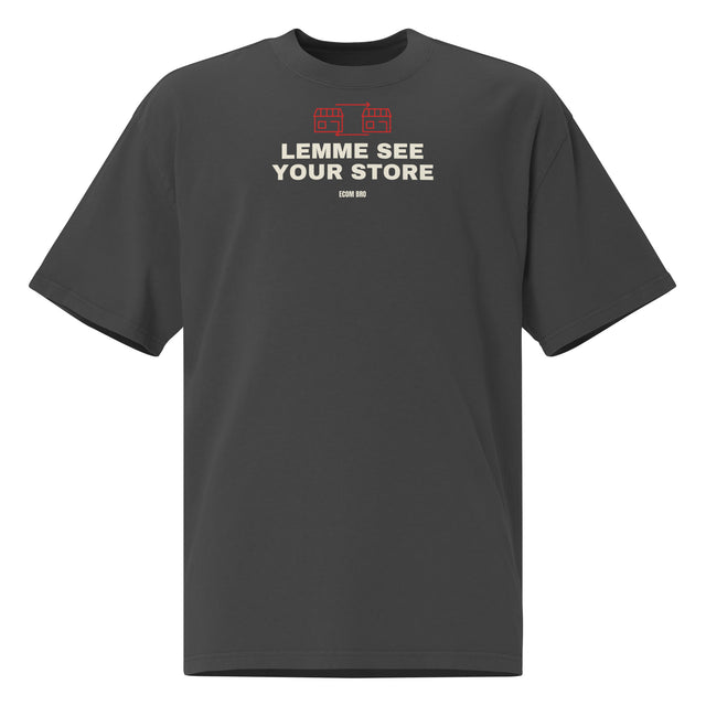 Supplier mockup, front of Faded Black cotton tee with red DTG storefront graphics, cream LEMME SEE YOUR STORE text and ECOM BRO signature.