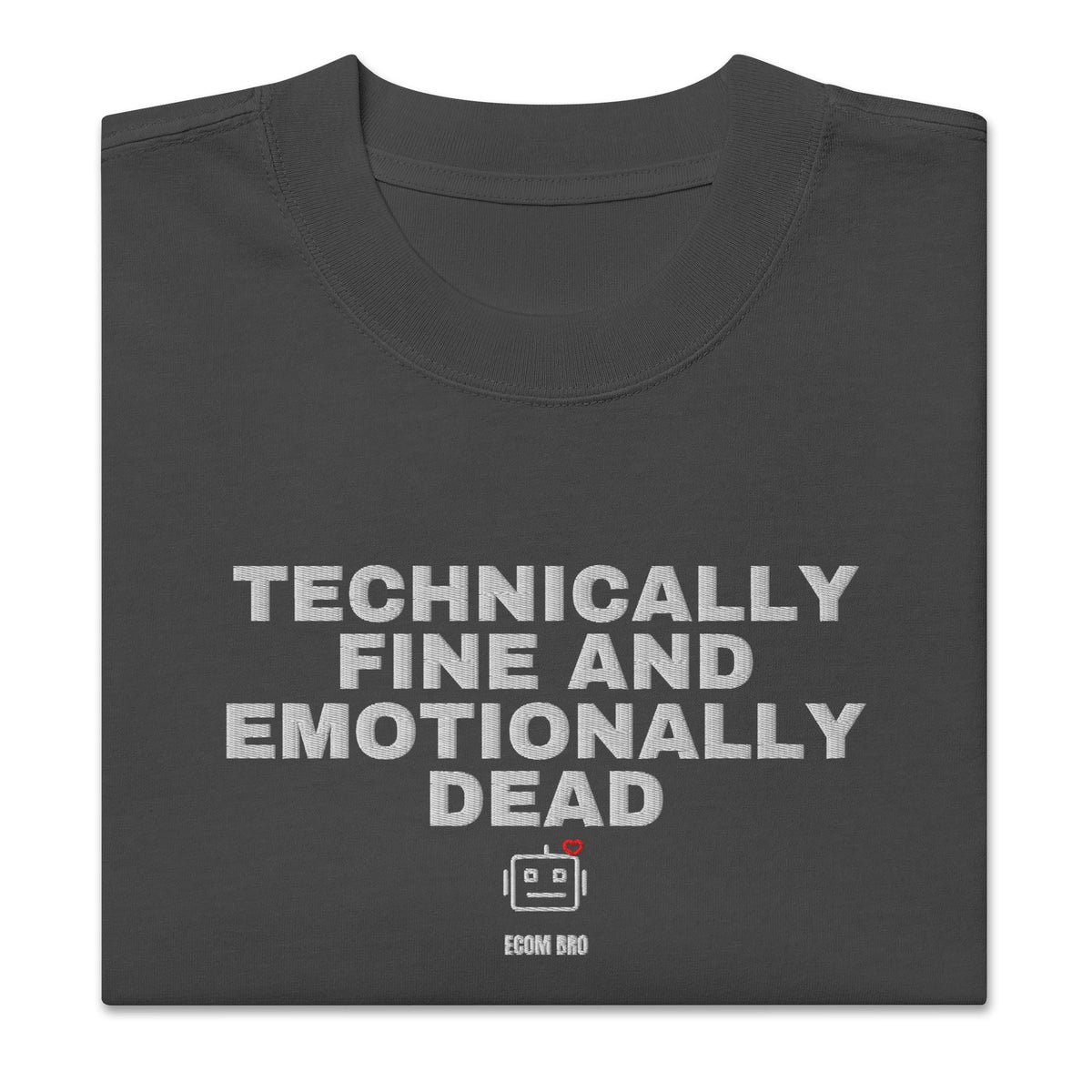 Supplier folded-front mockup: enlarged TECHNICALLY FINE AND EMOTIONALLY DEAD lettering with robot and ECOM BRO signature on Faded Black cotton
