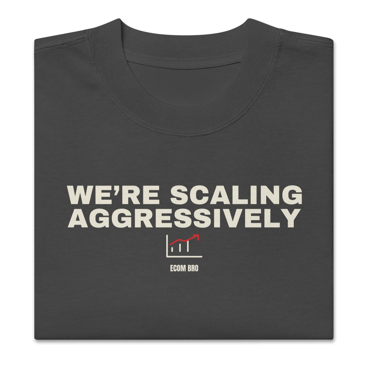 Supplier folded-front mockup: large WE’RE SCALING AGGRESSIVELY print with a red growth chart and ECOM BRO signature on Faded Black cotton