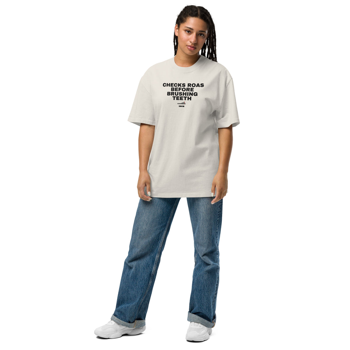 Supplier on-body mockup of a woman wearing the Faded Bone tee with CHECKS ROAS BEFORE BRUSHING TEETH lettering, toothbrush chart and ECOM BRO signature.